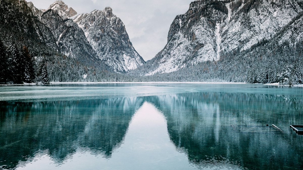 Snow-capped mountains reflected in a still alpine lake
