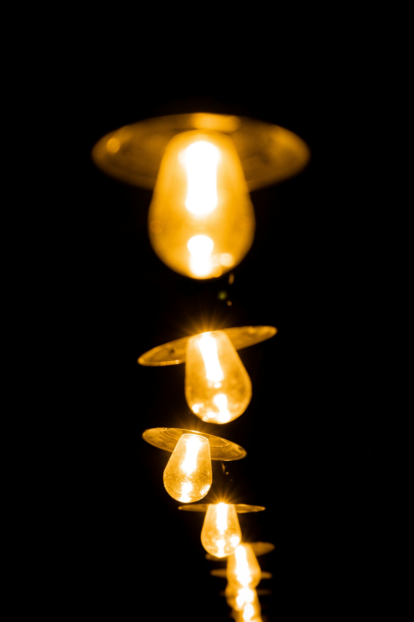 Group of lit candles in a dim room