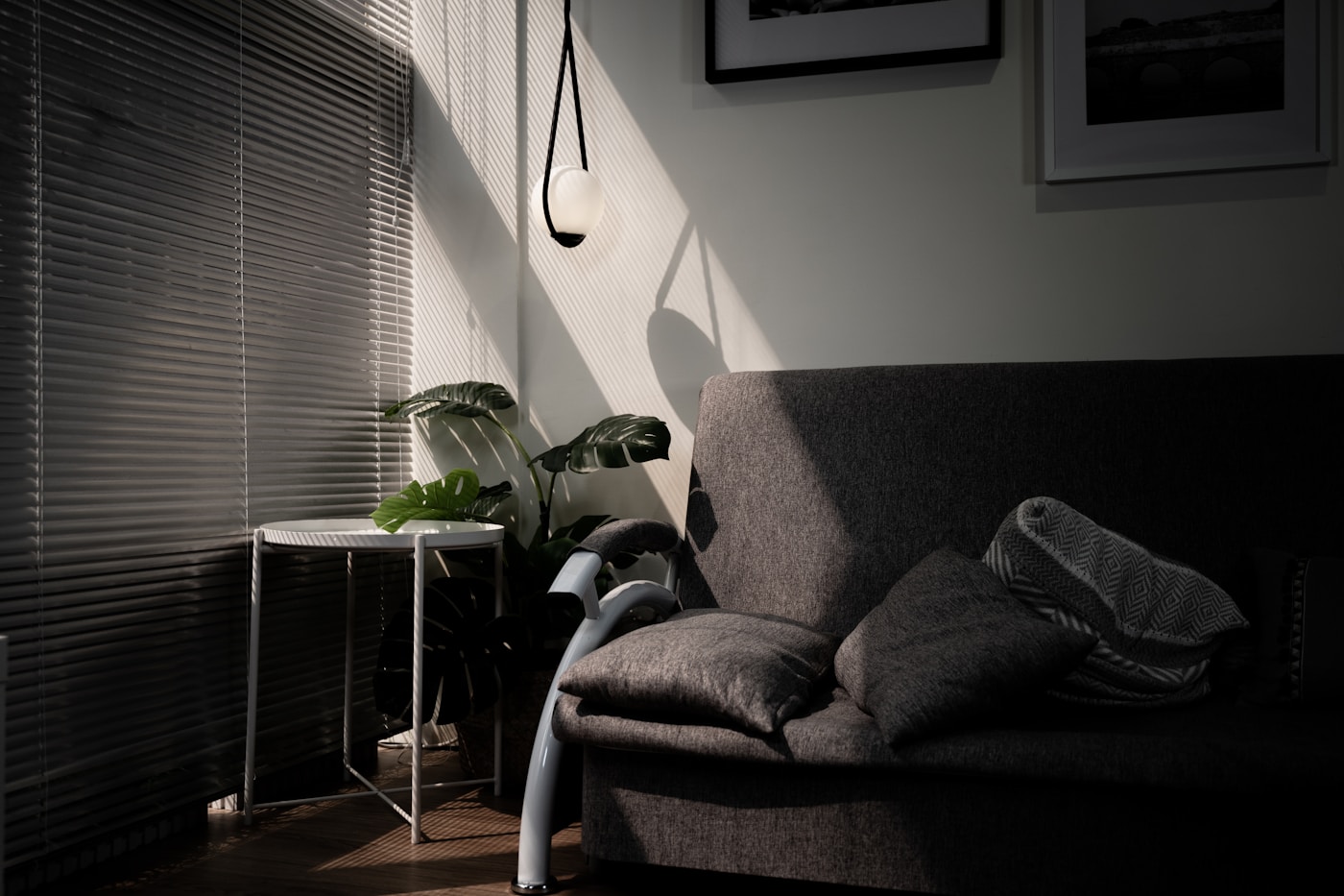 Gray sofa chair beside a window in soft daylight