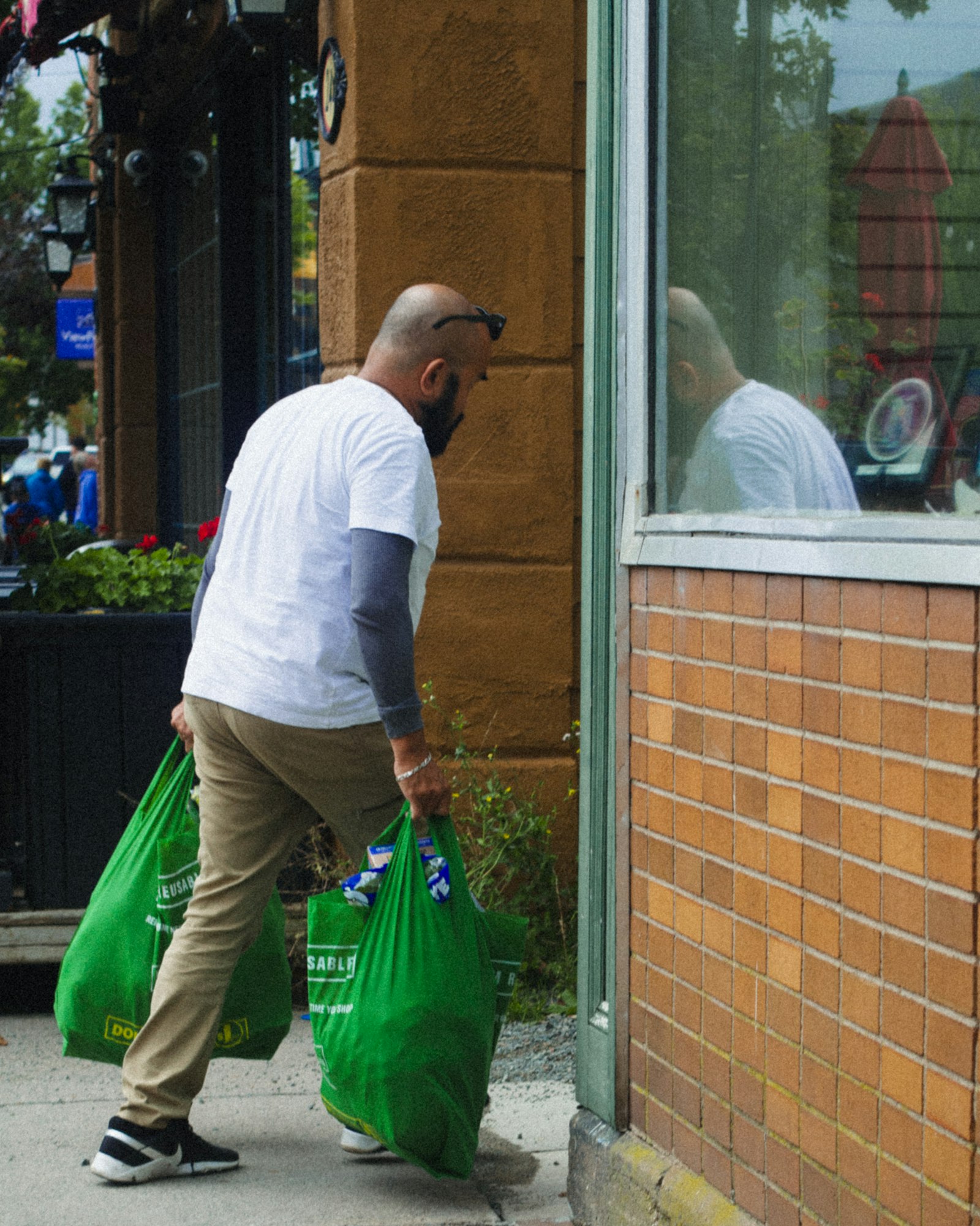 A person carrying two reusable shopping bags after running an errand