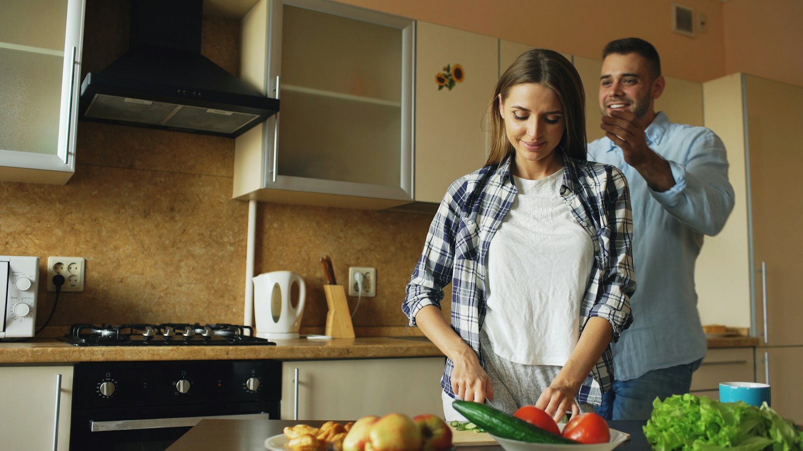 Couple preparing food together in a kitchen