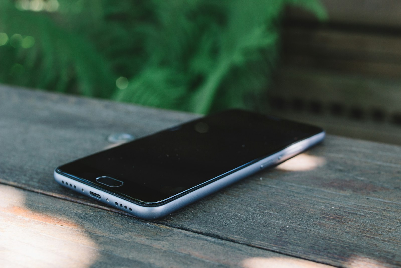 A smartphone left untouched on a wooden table